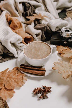 Coffee cup with spices. In the background are cozy cotton and woll sweatersの写真素材