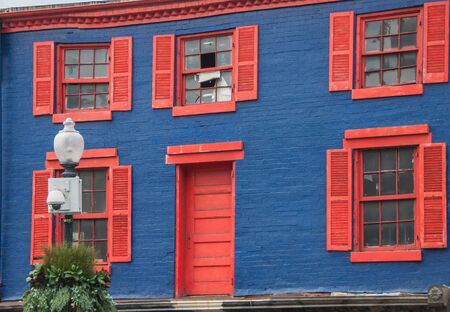 Dark blue house with red platsの写真素材