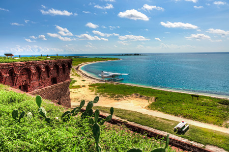 Beach, small airplane and turquoise ocean - tropical paradise island, Dry Tortugas, Florida, USの写真素材