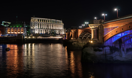 View on one on London bridges and Thames River at nightの写真素材