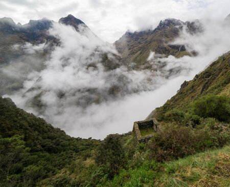 Stunning view from the Inca trail on mysterious Inca building covered with clouds.の写真素材