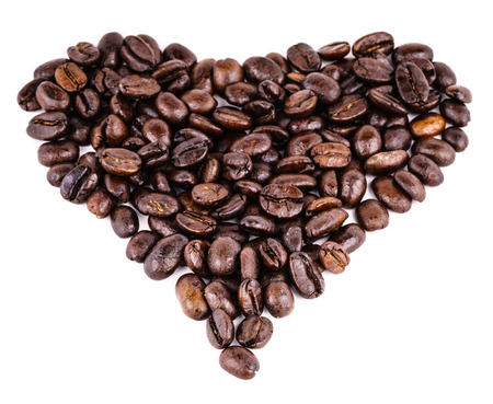 Heart made of coffee beans - coffee can be dangerous or good for your health conceptの写真素材