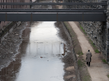 Homeless man walking at the canal in Washington, DCの写真素材