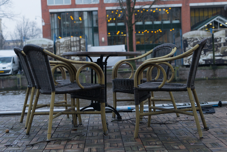 Beautiful old table and chairs at the canalの写真素材