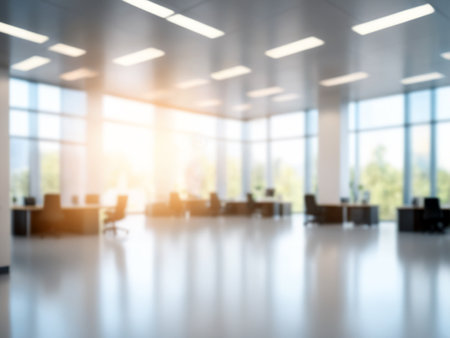 Blured modern office interior with warm sunlight and floor reflectionsの素材
