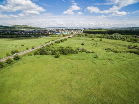 Cow, road, green near of border of Tatar and Bashkir state. Aerial view. Russiaの写真素材