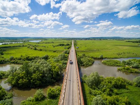Cow, road, green near of border of Tatar and Bashkir state. Aerial view. Russiaの写真素材