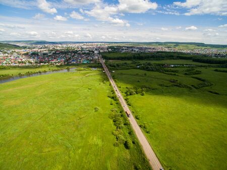 Cow, road, green near of border of Tatar and Bashkir state. Aerial view. Russiaの写真素材