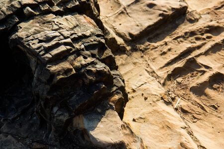Waves break on the rocky beaches of Arambol in India.の写真素材