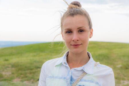 Beautiful summer portrait of a young woman with background of Shikhan mountain, Tra-Tau, Russia, Bashkortostan, South Uralの写真素材
