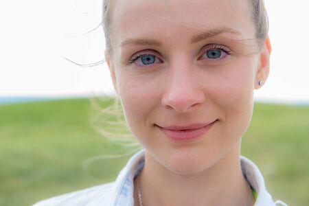 Beautiful summer portrait of a young woman with background of Shikhan mountain, Tra-Tau, Russia, Bashkortostan, South Uralの写真素材