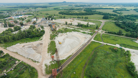 Flying over the excavator in a quarry. Shikhan mountain Yuraktau Russia, Bashkortostan, South Ural.の写真素材