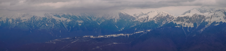 Panoramic view of the Caucasus mountains in the cloudy winter weatherの写真素材