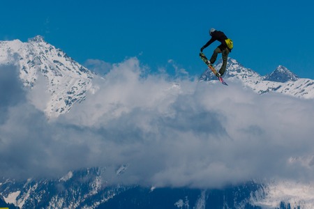 2017 04 Sochi, Russia, Festival NewStarCamp: snowboarder jumps from a high springboardのeditorial素材