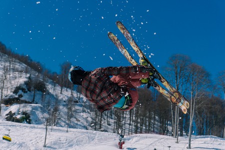 The skier in mountains in flight from a springboardのeditorial素材