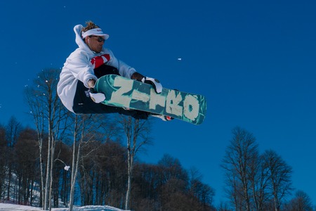 2017 04 Sochi, Russia, Festival NewStarCamp: snowboarder jumps from a high springboardのeditorial素材