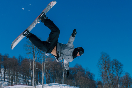 2017 04 Sochi, Russia, Festival NewStarCamp: snowboarder jumps from a high springboardのeditorial素材