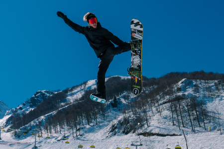 2017 04 Sochi, Russia, Festival NewStarCamp: snowboarder jumps from a high springboardのeditorial素材