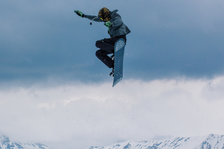 2017 04 Sochi, Russia, Festival NewStarCamp: snowboarder jumps from a high springboardのeditorial素材