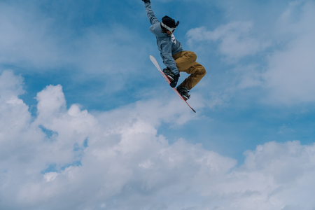 2017 04 Sochi, Russia, Festival NewStarCamp: snowboarder jumps from a high springboardのeditorial素材