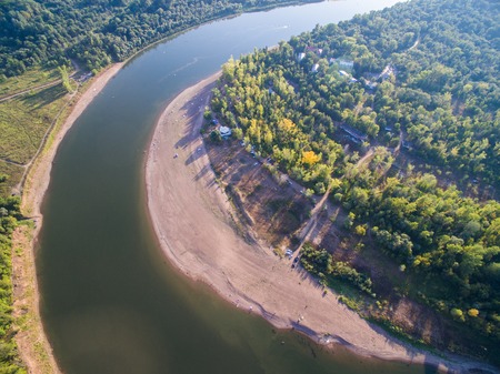 A river in the middle of a forest close to the city. Aerial survey of recreation centerの写真素材