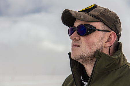 2014 07 Mount Elbrus, Russia: Man looks at the top of Elbrusのeditorial素材