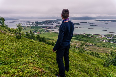 A man watching a landscape of village in Norway, Scandinaviaの写真素材