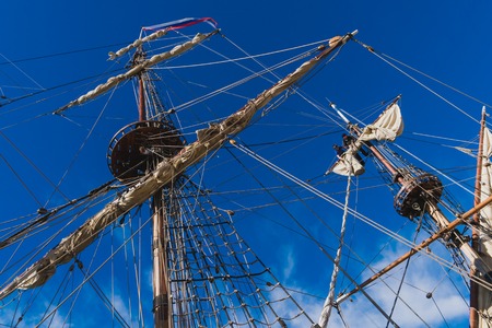 Sailors work with sails at a height on a traditional sailboatの写真素材