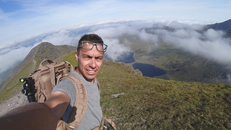The man on the top of Carrauntoohil makes a selfieの写真素材