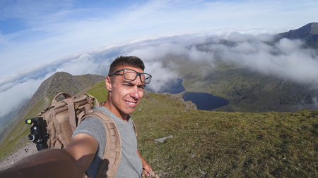 The man on the top of Carrauntoohil makes a selfieの写真素材
