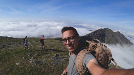 The man on the top of Carrauntoohil makes a selfieの写真素材