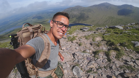 The man on the top of Carrauntoohil makes a selfieの写真素材
