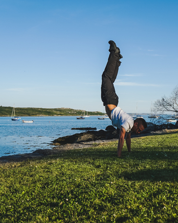 man stands on the hands against the background of yachtsの写真素材