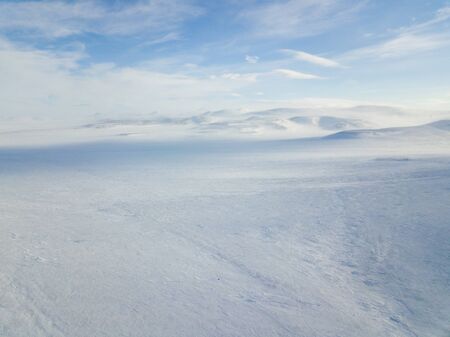 The cars rides on the snow-covered tundra ice in the far north. Aerial photographyの写真素材