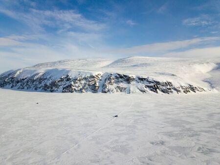 The cars rides on snow-covered tundra in the vicinity of the Arctic Oceanの写真素材