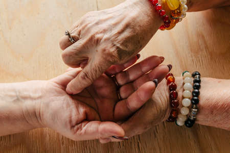 Grandma magic, fortune telling, palmistry. Chiromancy, women hands, destiny readingの写真素材