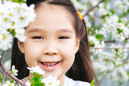 Close up portrait of an Asian girl with spring flowersの写真素材