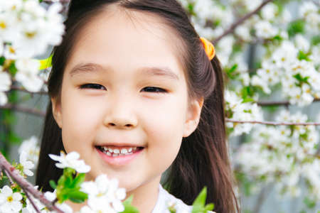 Close up portrait of an Asian girl with spring flowers