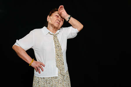 Portrait of an elderly senior Asian woman, thinking and feeling tiredness and fatigue