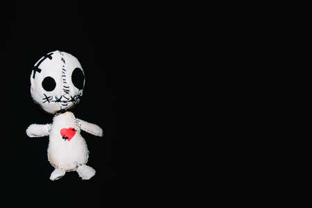 Voodoo magic ritual doll on a black background.の写真素材