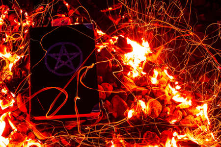 Black magic book. Beautiful occult ritual. Power of fire. Spitirual mood.の写真素材