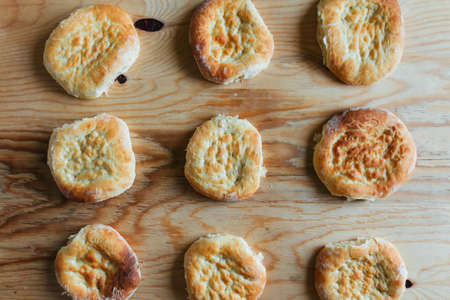 Cooking at home, rows of fresh tasty flatbreads on a wooden tableの写真素材