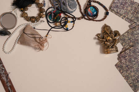 Table with occult attributes, top view. Ganesha figurine, stone rosaries, candles, aroma stickの写真素材