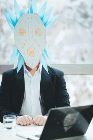 Asian businessman with tambourine in shamanic mask. Concept of attracting success, wishing good luck...