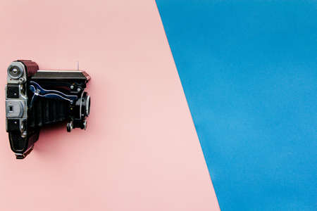 vintage camera on pink and blue pastel background, magazine style, good for designers, presentationsの写真素材