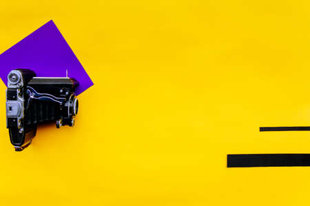 vintage photo camera on yellow background, good for design, presentstion, trendy magasine style