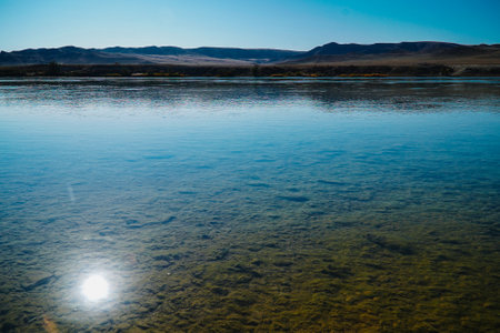 The reflection of sunlight in the blue water. Steppe Riverの写真素材