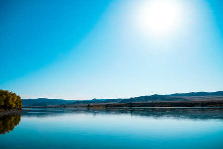 Stunning symmetrical wildlife photo. Blue river landscape in the hillvallieの写真素材