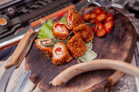 Beef roll in polishing with pepper and herbs on a boardの写真素材