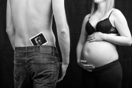 pregnant couple in love with baby bellyの写真素材